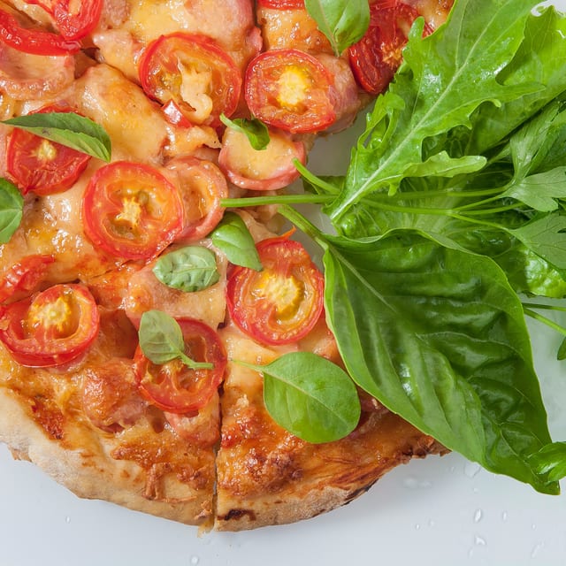 Fresh tomato & mozzarella pizza slice.