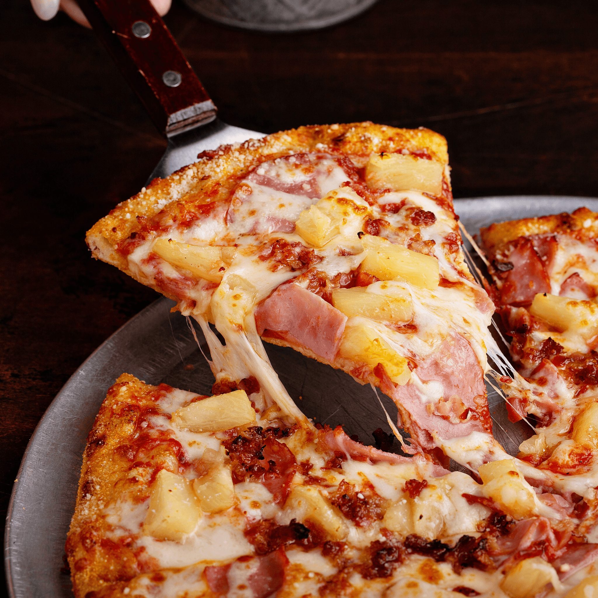 Hawaiian pizza slice.